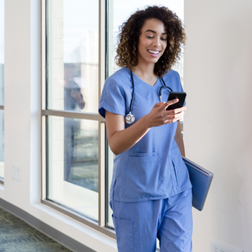 Healthcare worker smiling at smartphone