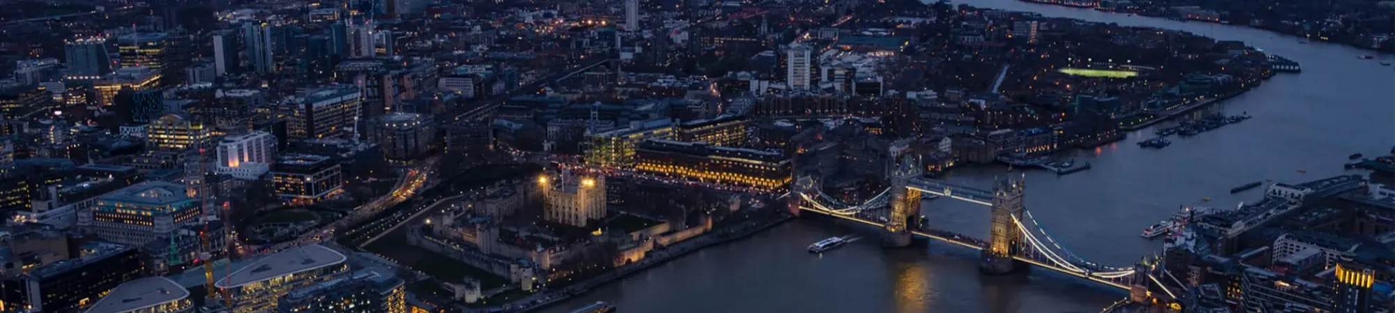 Ariel view of London at night with Tower Bridge and River Thames