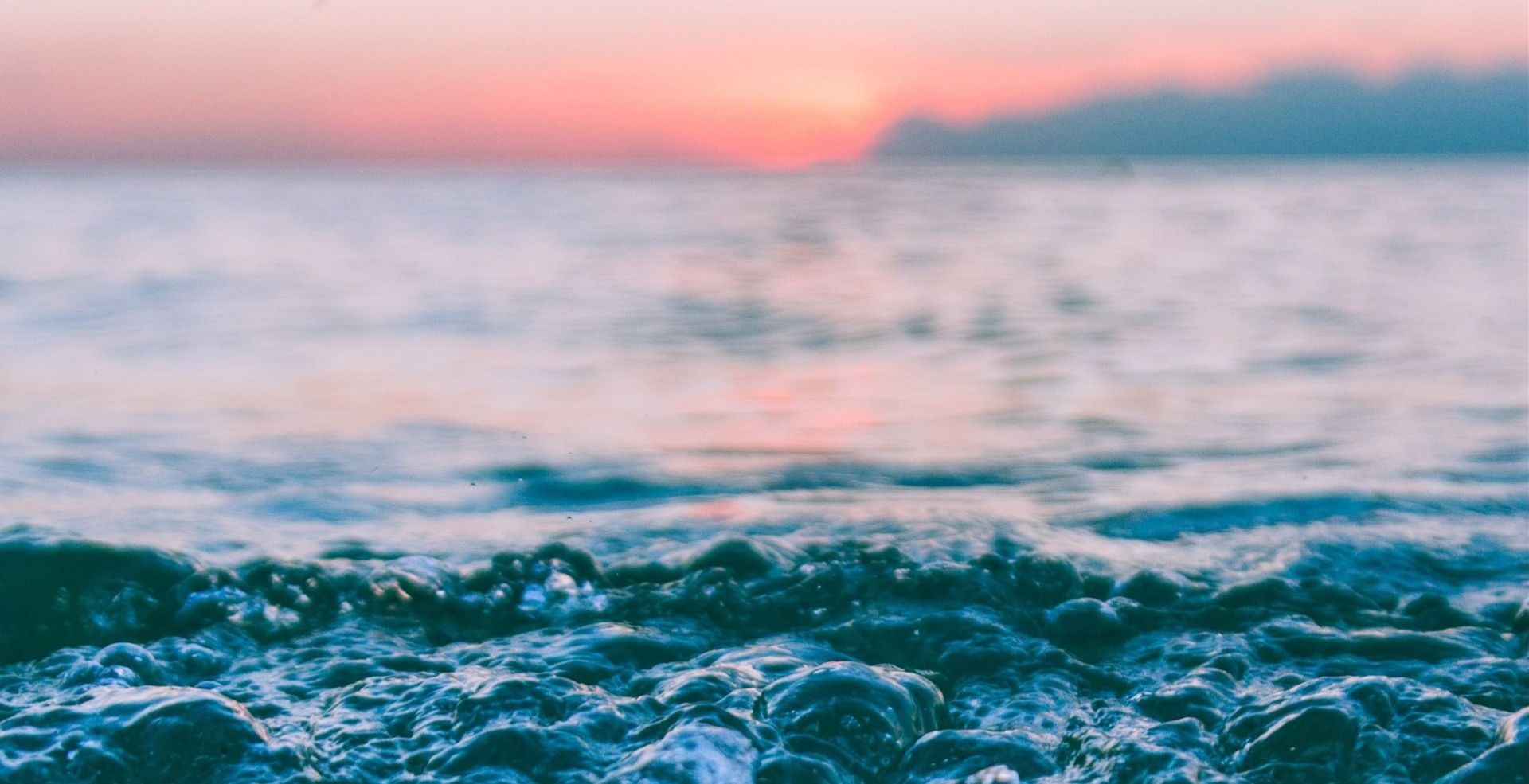 closeup of ocean waves with sunset