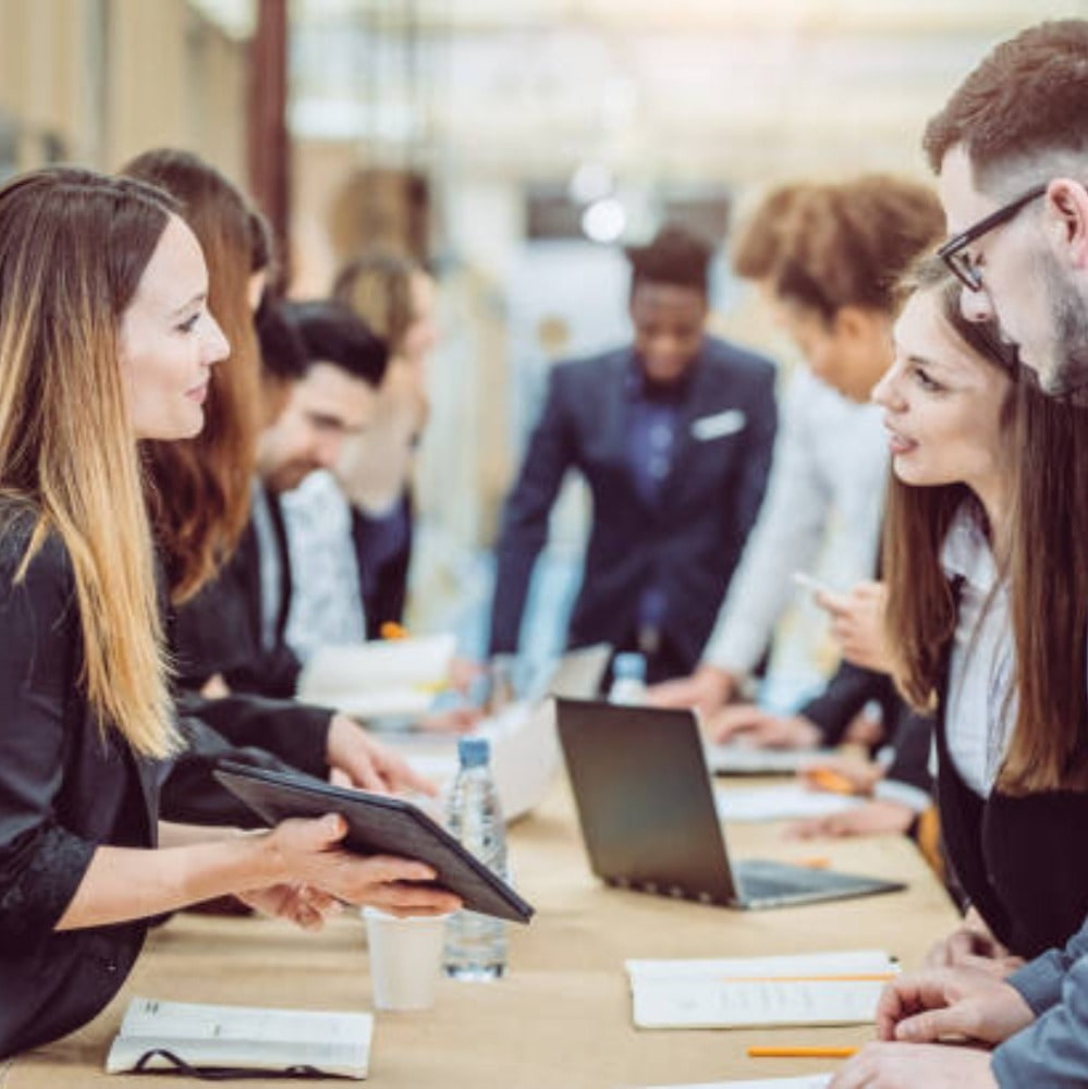 Employees having a meeting in their job