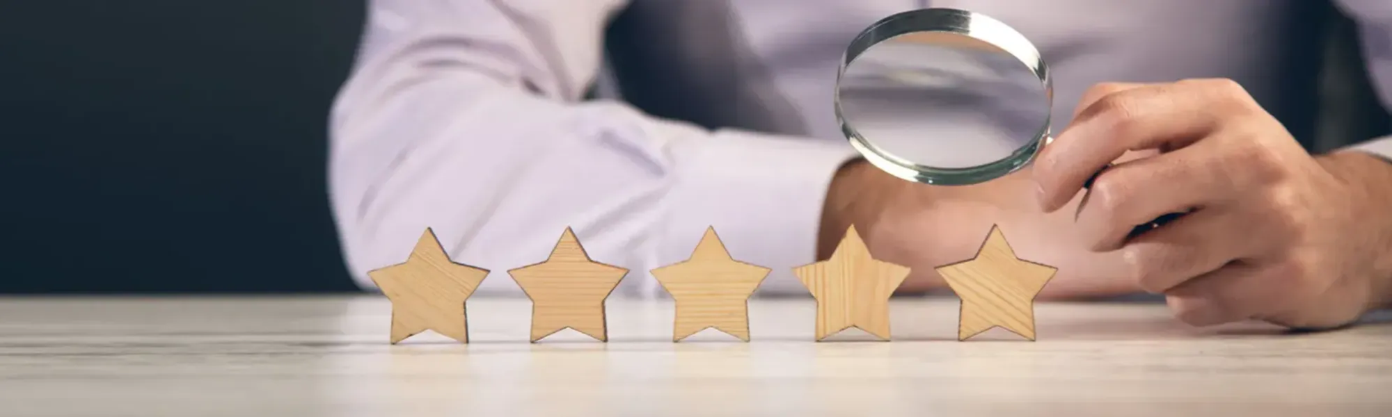 Client inspecting five star review with magnifying glass