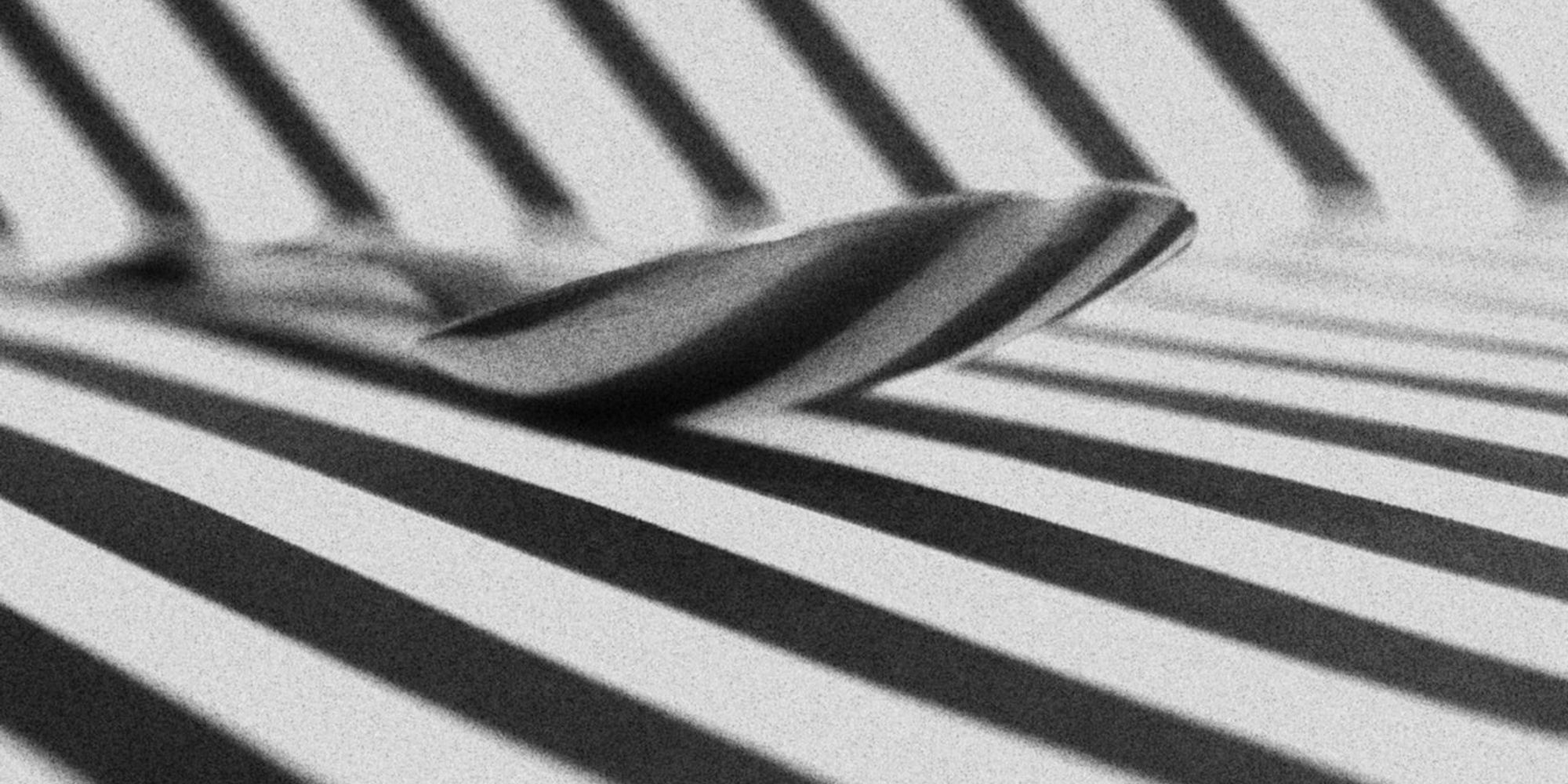 Spoon On A Surface With Black And White Stripes 3383956