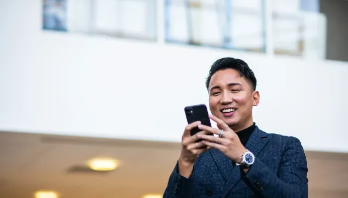 person smiling holding phone