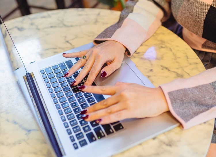 woman typing on a laptop