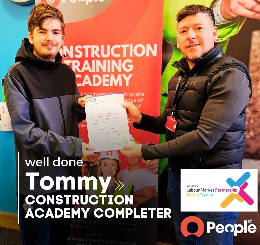 Recent graduate Tommy receives his award from Construction Academy manager Don Burns 