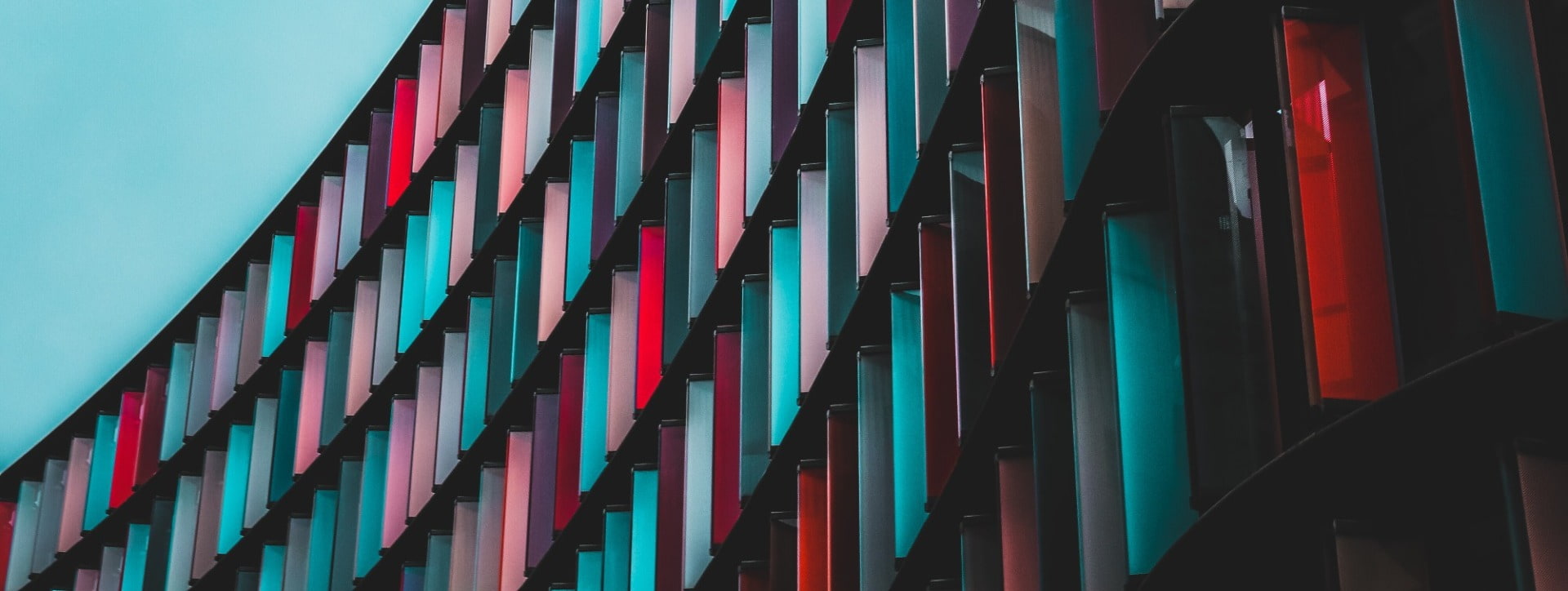 Multi-coloured building banner with blue, red, pink, purple