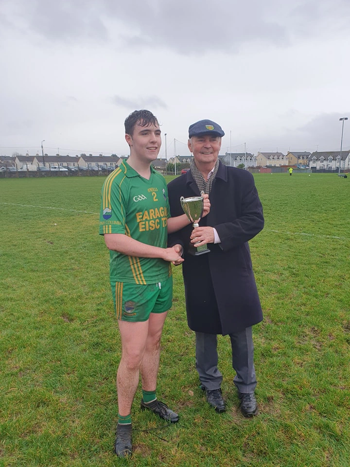 Gary receives his GAA Trophy from Donegal legend Brian McEniff