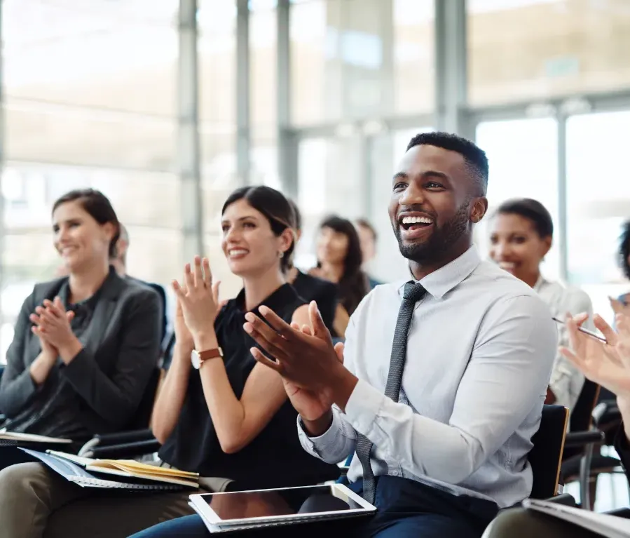 A group of seated people applauding