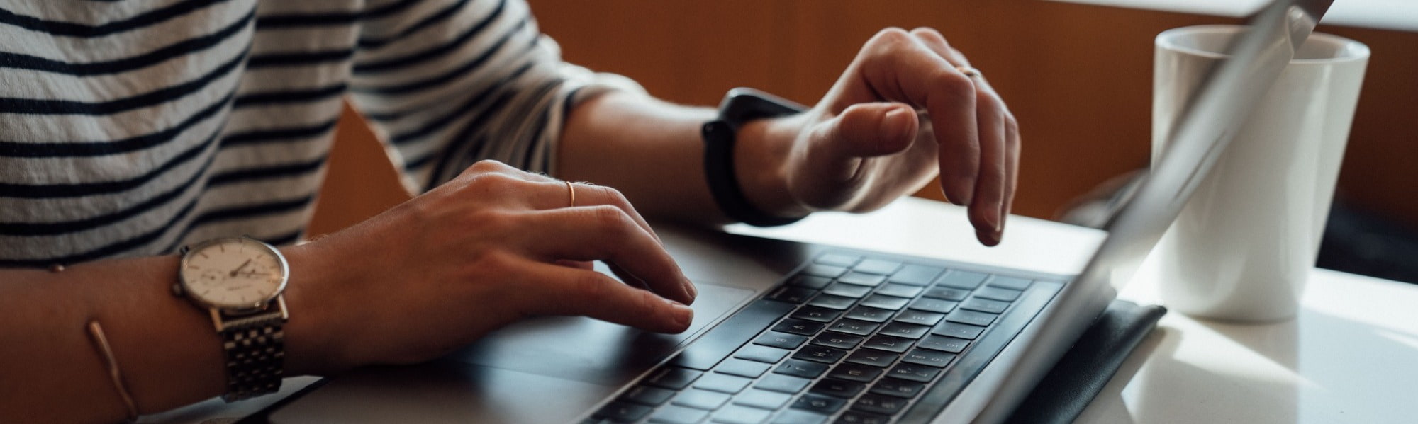 person typing on laptop preparing cv resume for job interview application