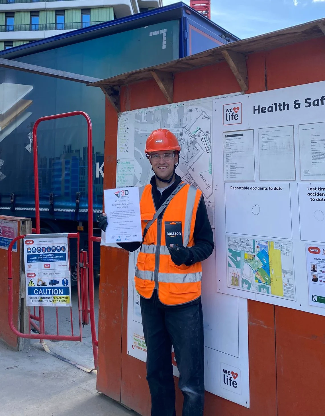 Sam displays his award on site at Ebury Bridge Estate