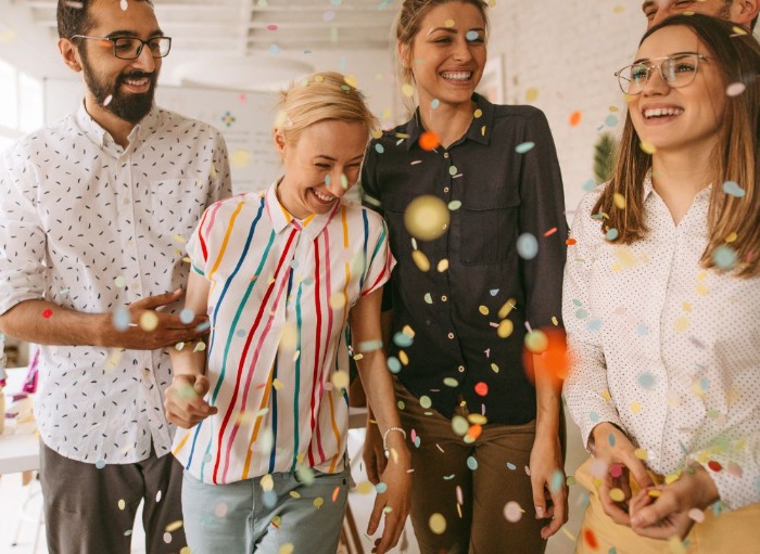 office workers celebrating with confetti