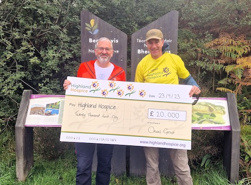 2 guys holding a big cheque