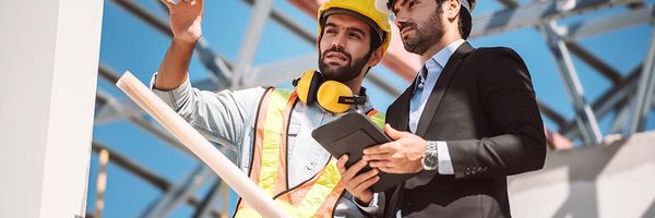Civil Engineer Construction Worker Manager Holding Digital Tablet Blueprints Talking Planing About Construction Site Cooperation Teamwork Concept 1024x683