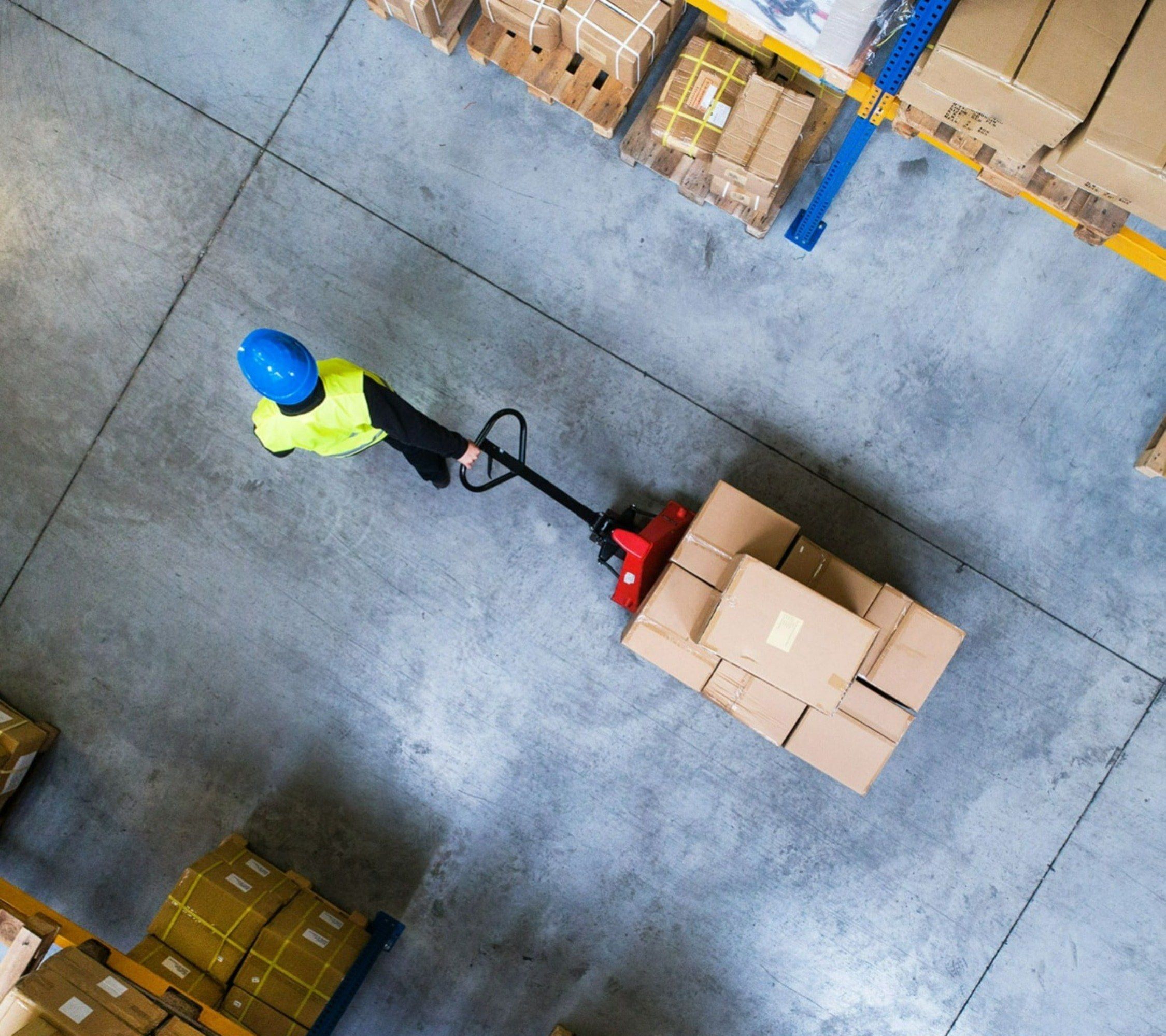 Warehouse worker moving boxes using a cart