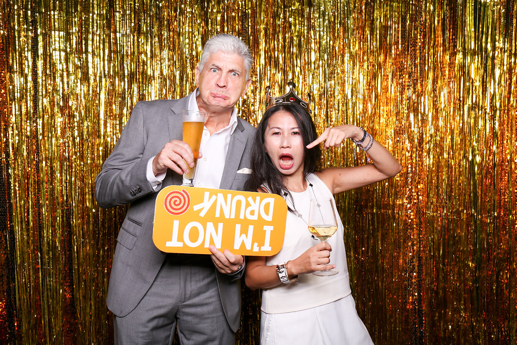 Photobooth photo with man and woman holding funny sign