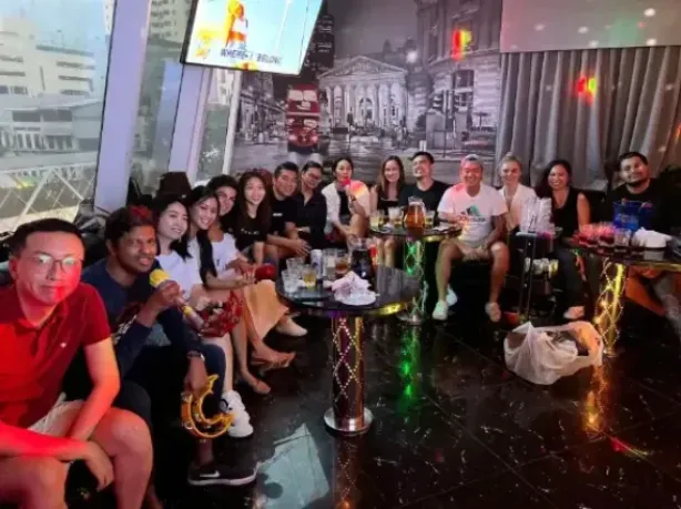 A group in a dimly lit karaoke club