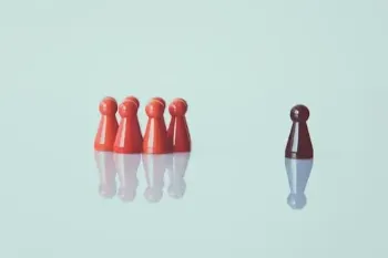 Several red pawns positioned against a white background, representing a team with one member identified as the leader.