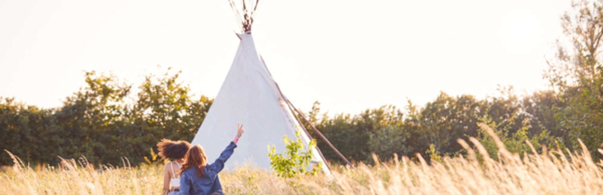 Farm glamping site with girls running