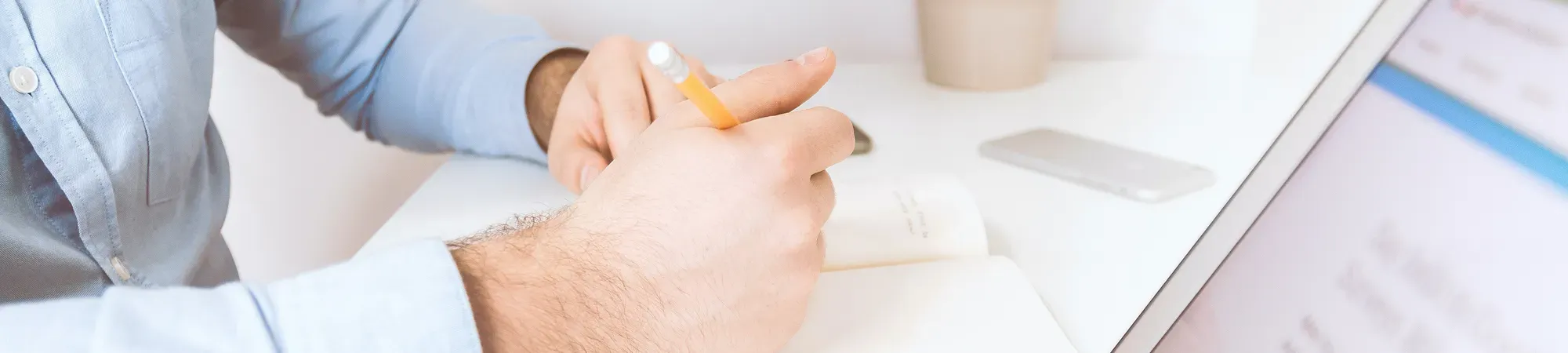 Generic image of a person writing in a notepad