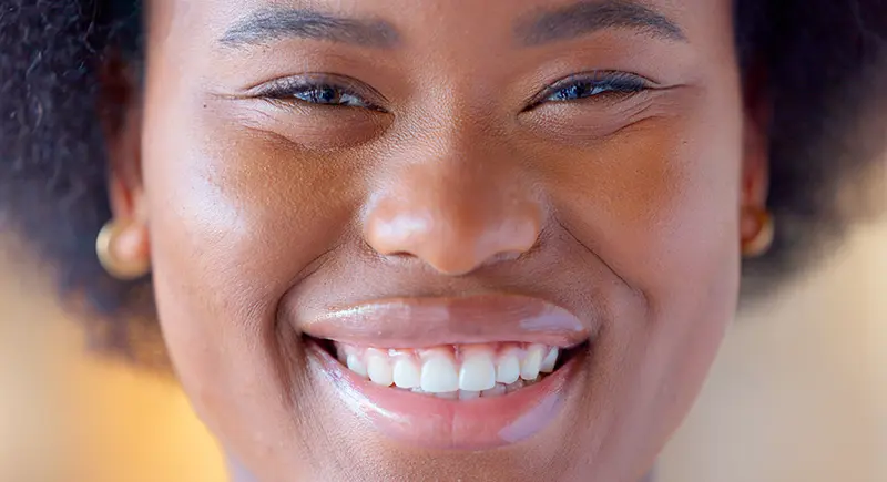 Close up of person smiling.