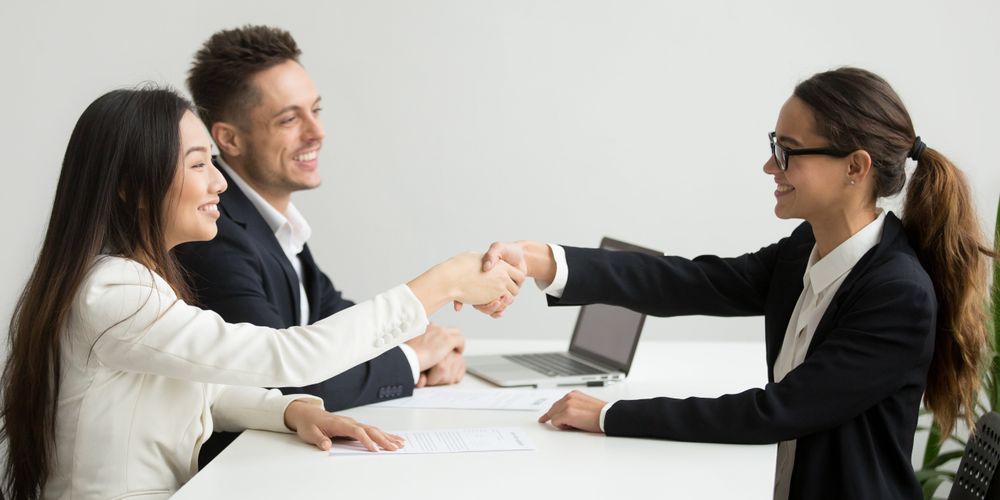 Smiling Diverse Businesswomen Shake Hands Group Meeting Deal Concept Min