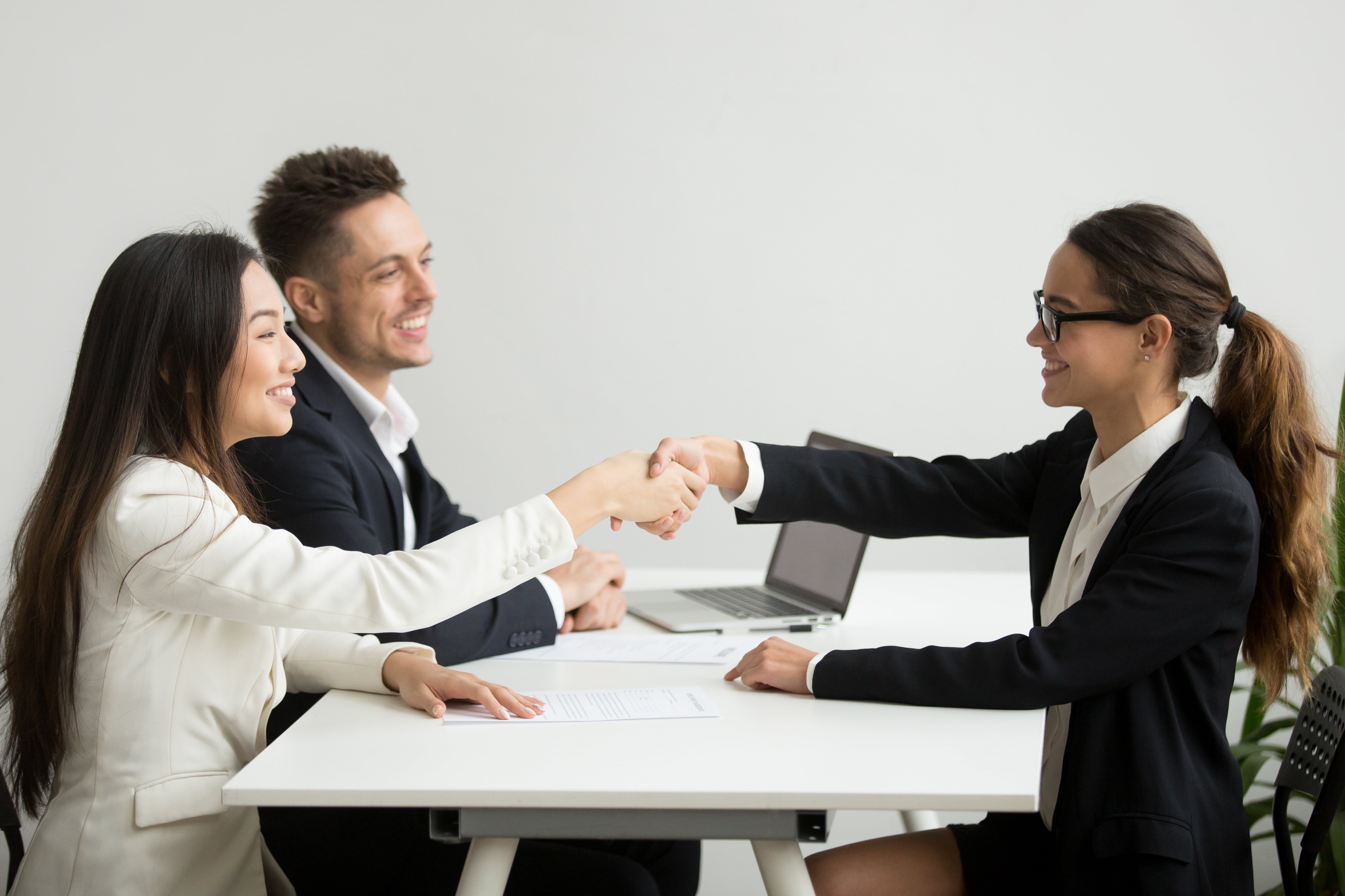 Smiling Diverse Businesswomen Shake Hands Group Meeting Deal Concept Min