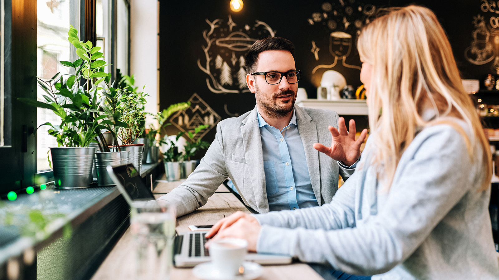 man-and-woman-talking-at-modern-working-space