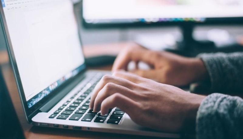 Person typing on laptop