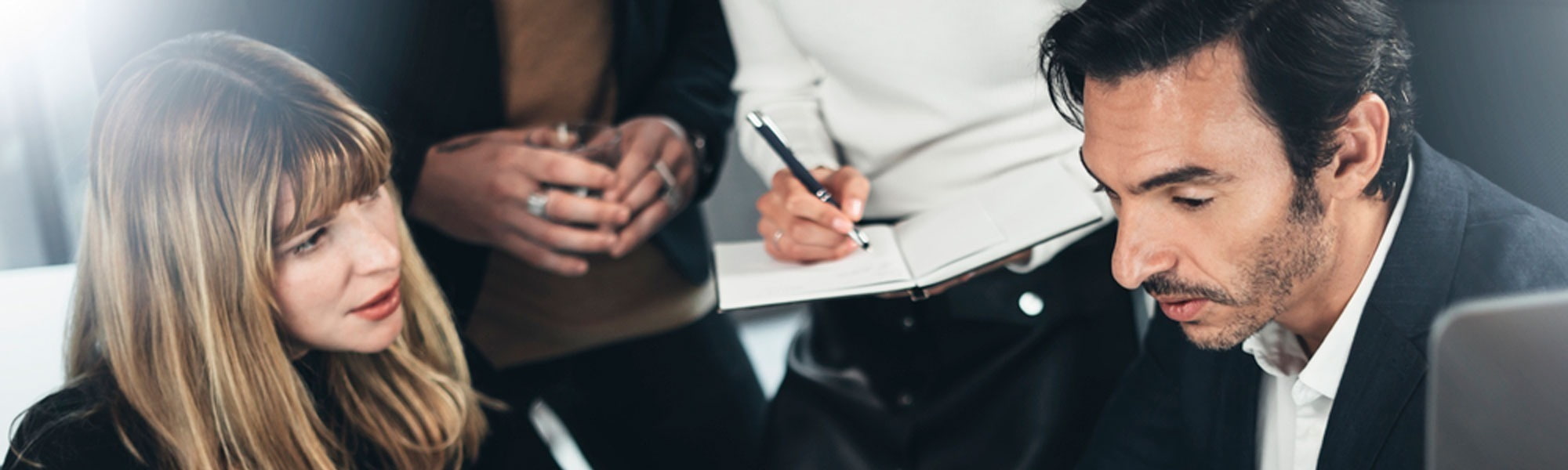 A female finance professional has a meeting with a smartly dressed male colleague