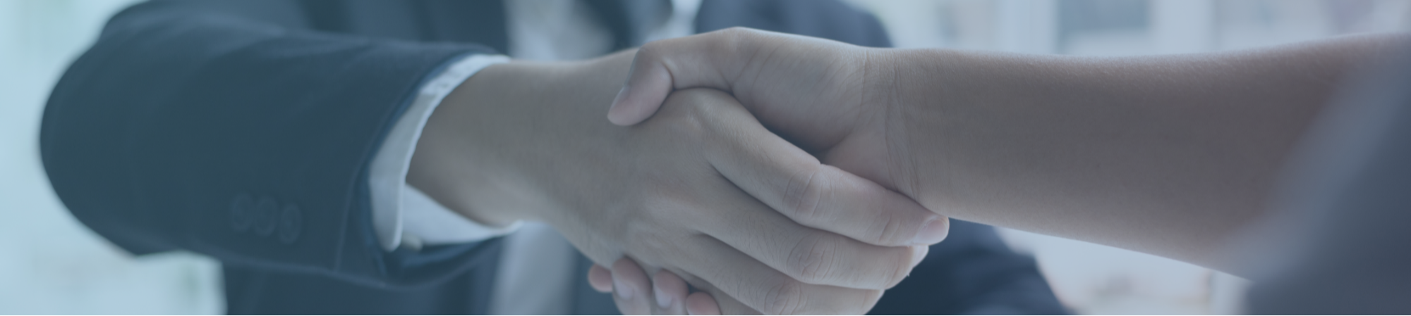 Candour Talent Recruitment Agency - Partner with us Page. Main banner of a handshake in a professional working environment, symbolizing our commitment to forging strong partnerships and collaborations.