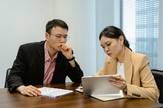 Two people having a conversation in an office