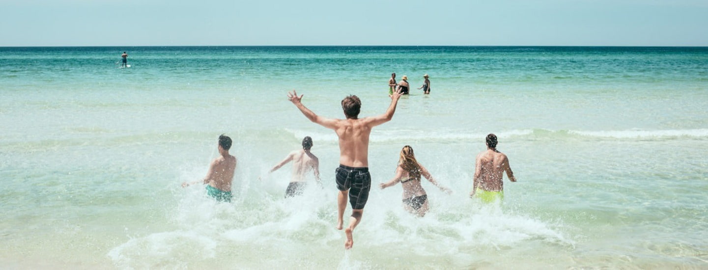Family having fun on a beach in Jersey after returning to work on the island