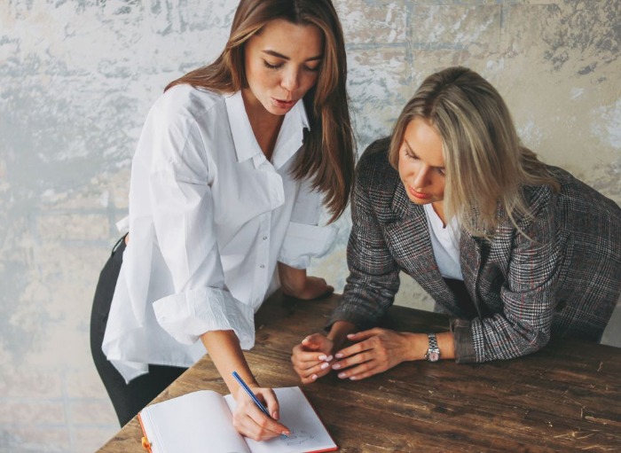 Woman helping her female colleague