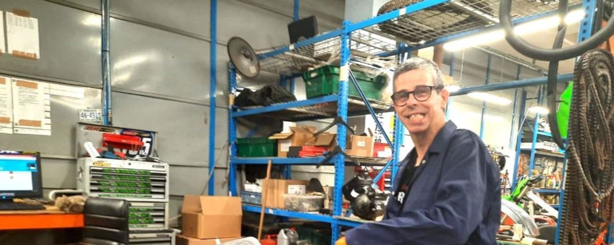 A man with a learning disability volunteers at a mechanics garage