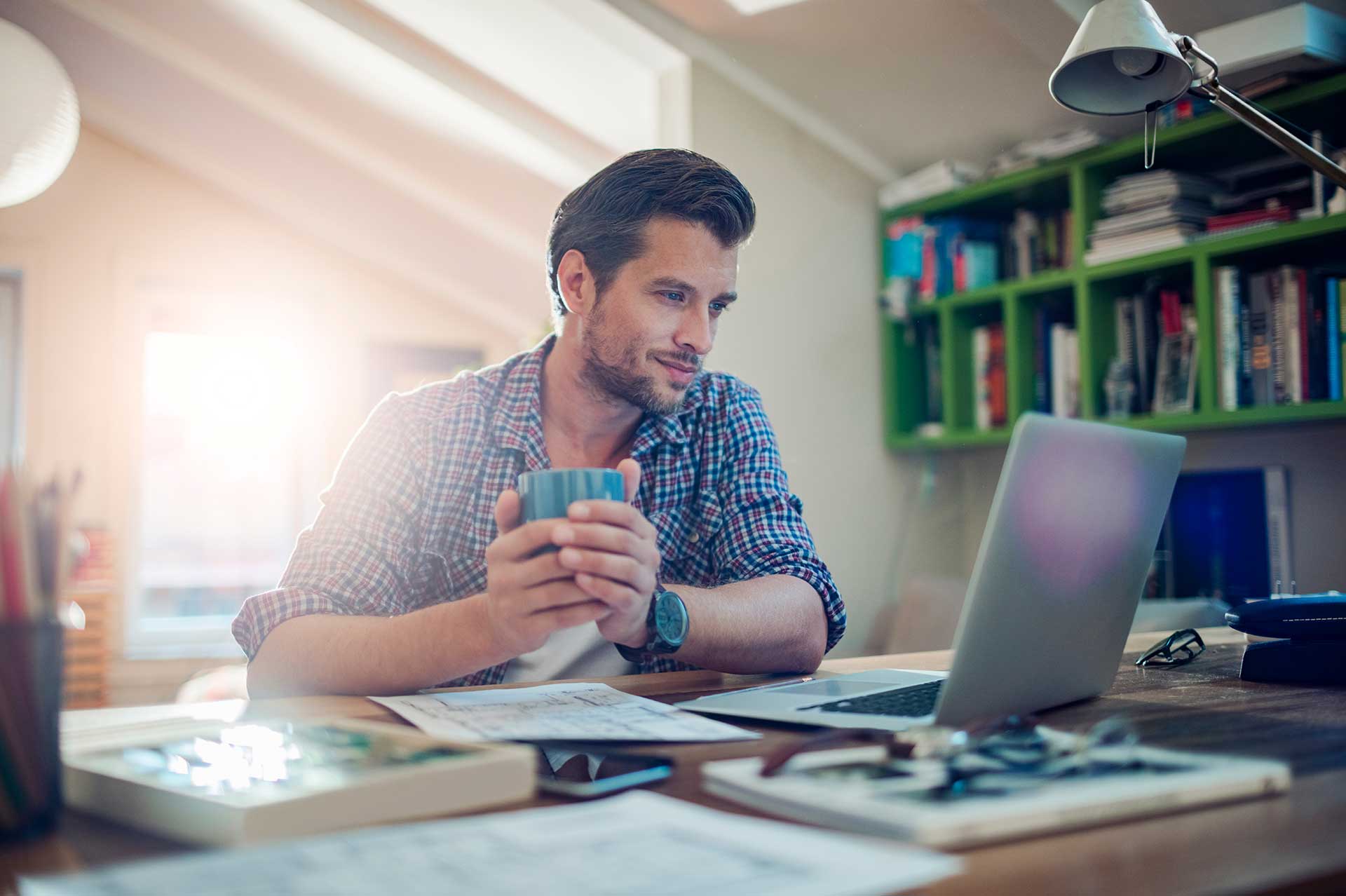 Man Working At Home On Laptop