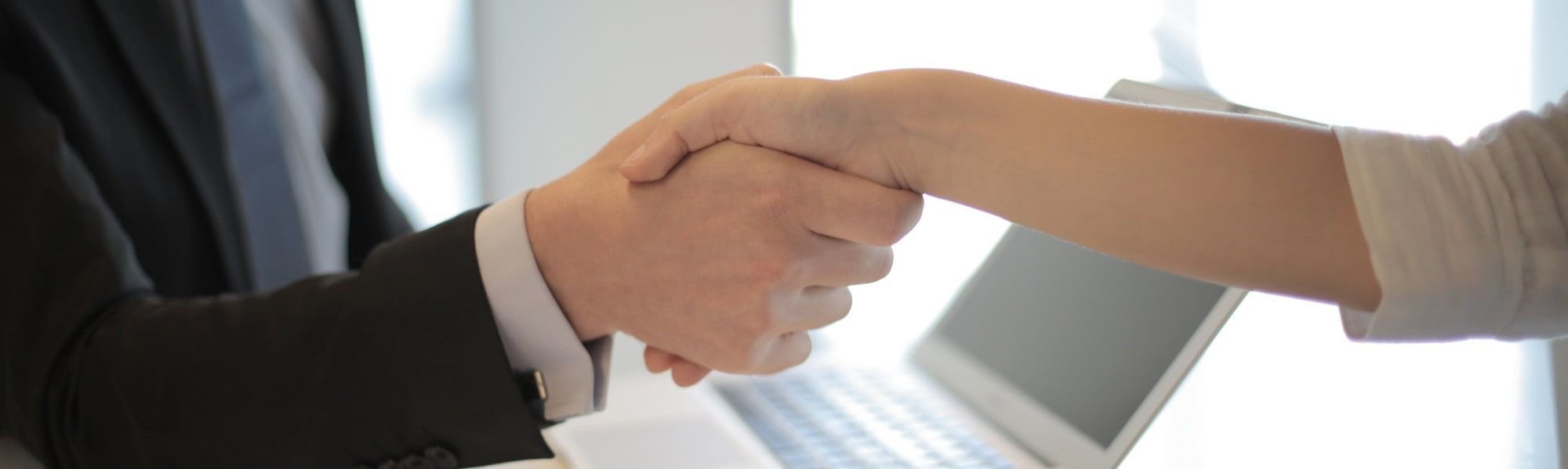 close up picture of 2 people shaking hands