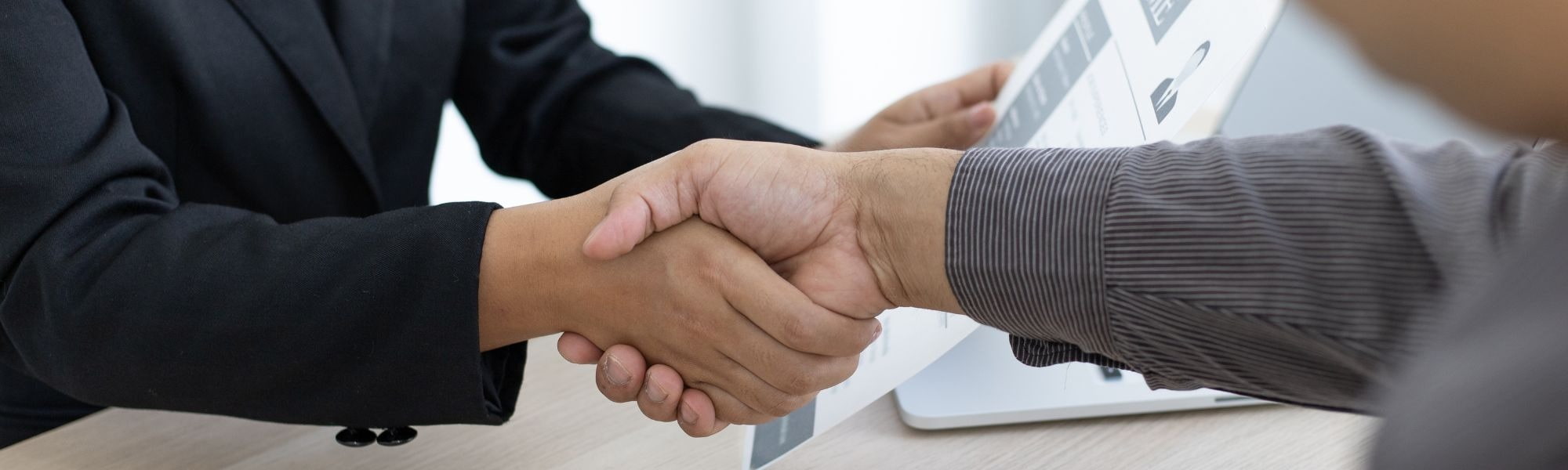 two people shaking hands business meeting interview