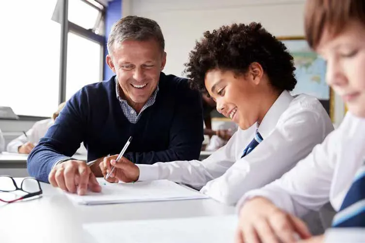 Photo of  2 people discussing a document