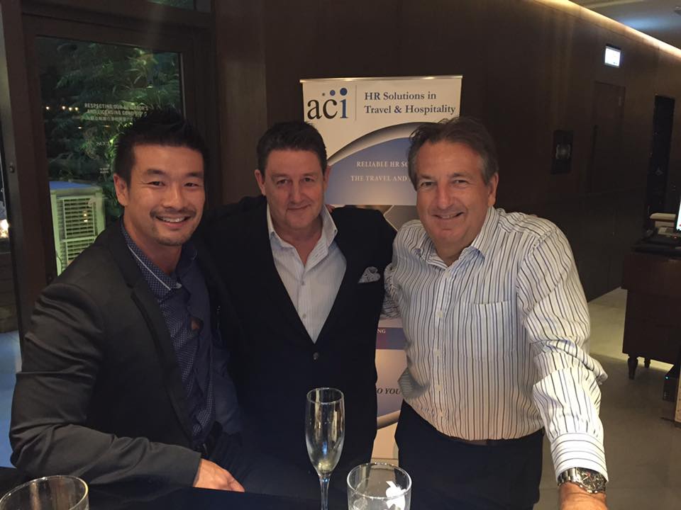 Andrew Chan networking with two men