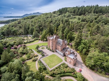 A castle surrounded by trees  AI-generated content may be incorrect.