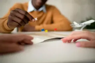 A man points to a map on a table, indicating potential career directions and opportunities.