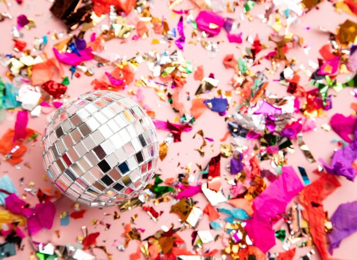 Disco ball surrounded by multicolour confetti