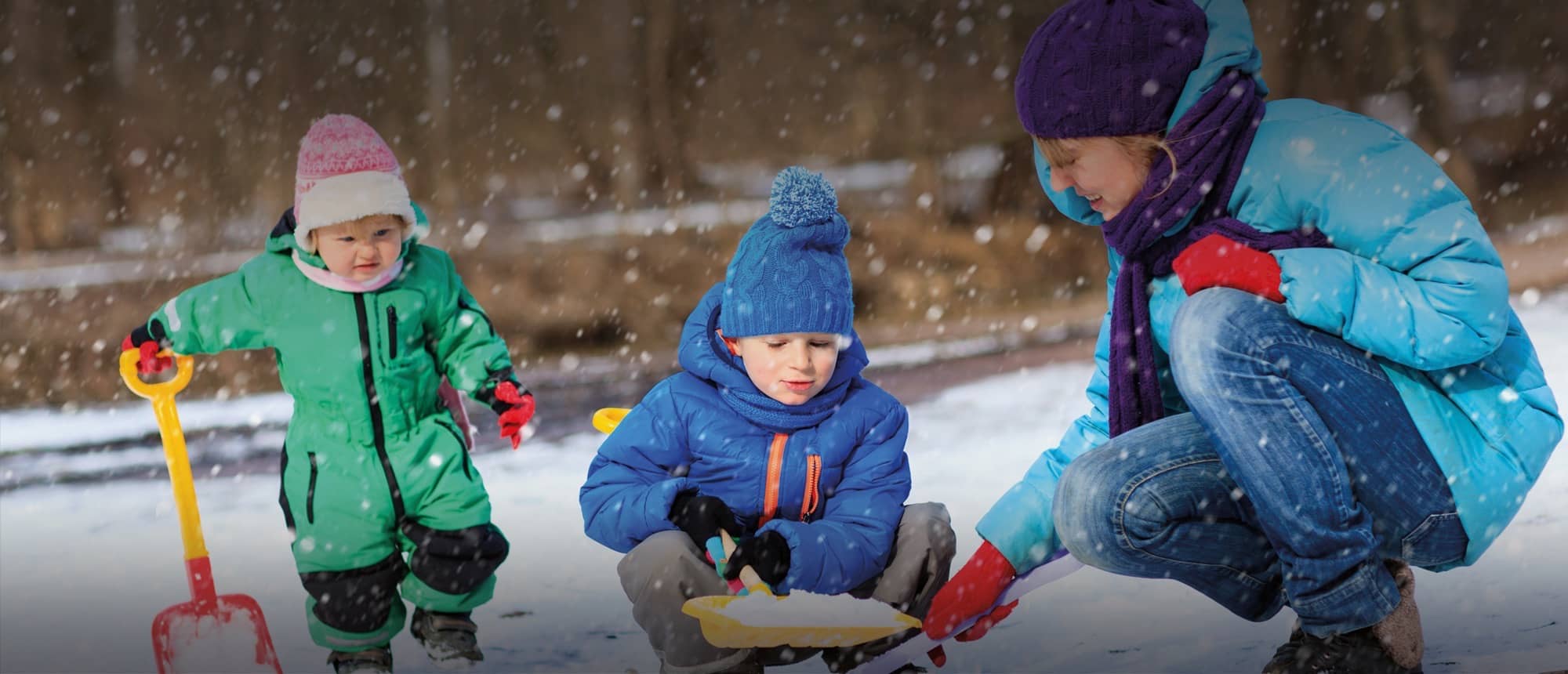 Nanny with children in the snow