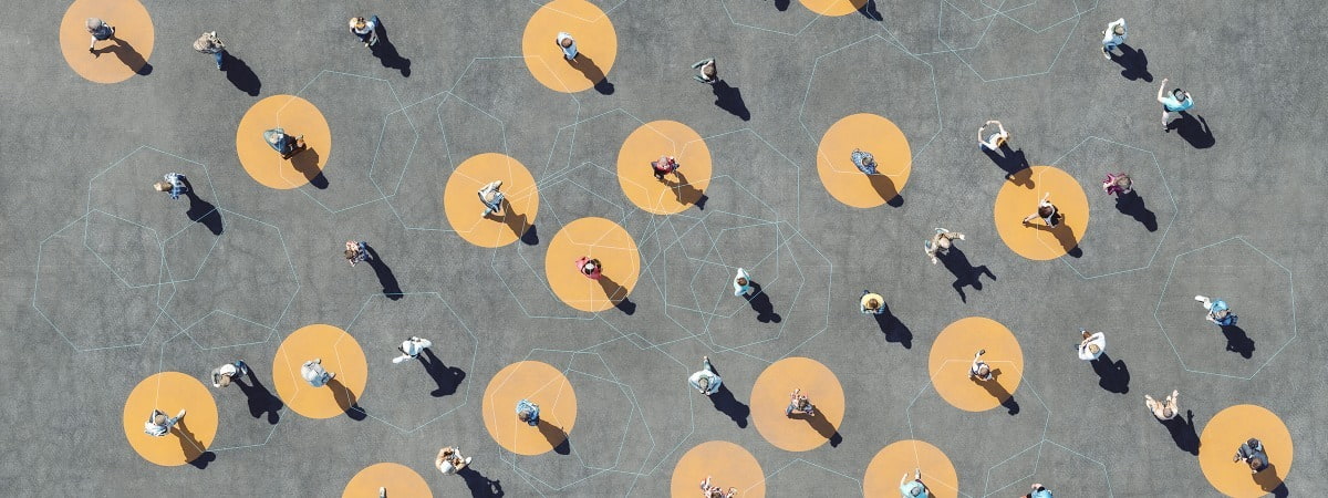 people standing in a concrete area some in yellow dots