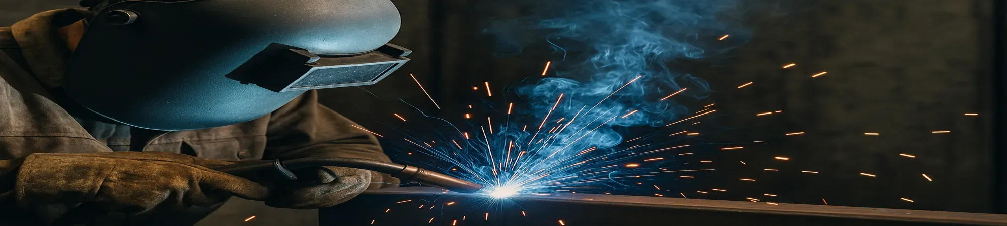Welder wearing welding mask at work