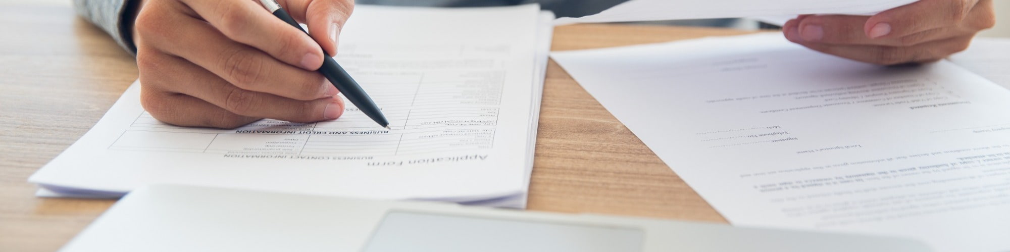 man filling in form sitting at desk  preparing for job interview