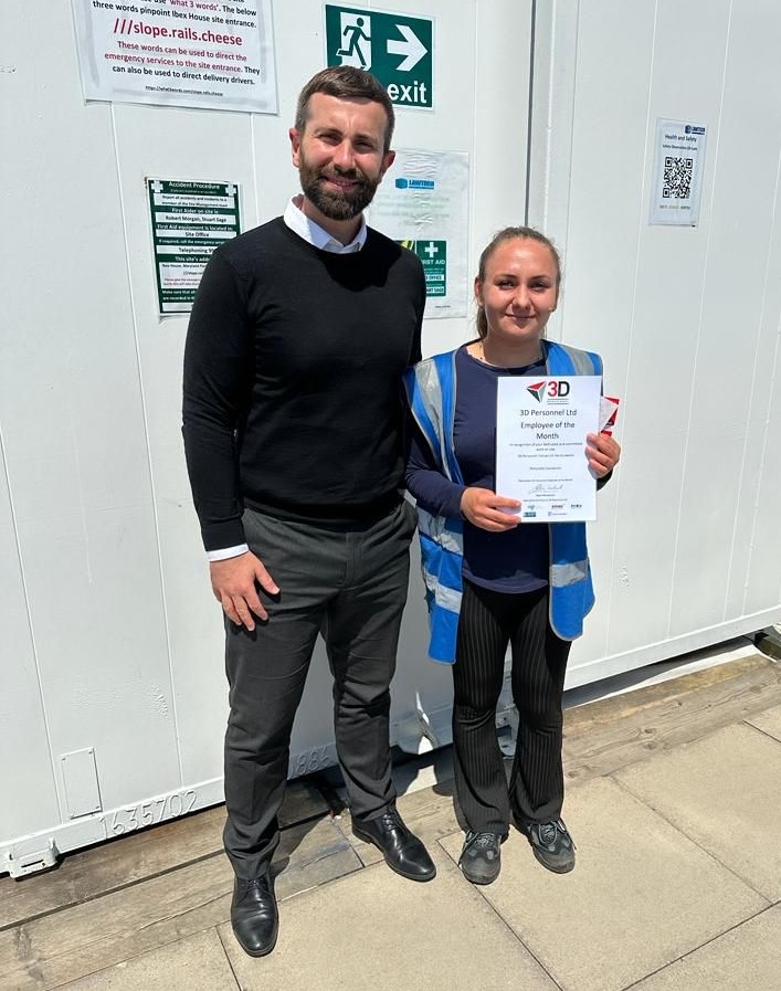 Michael presents Petronela with her award at the site office