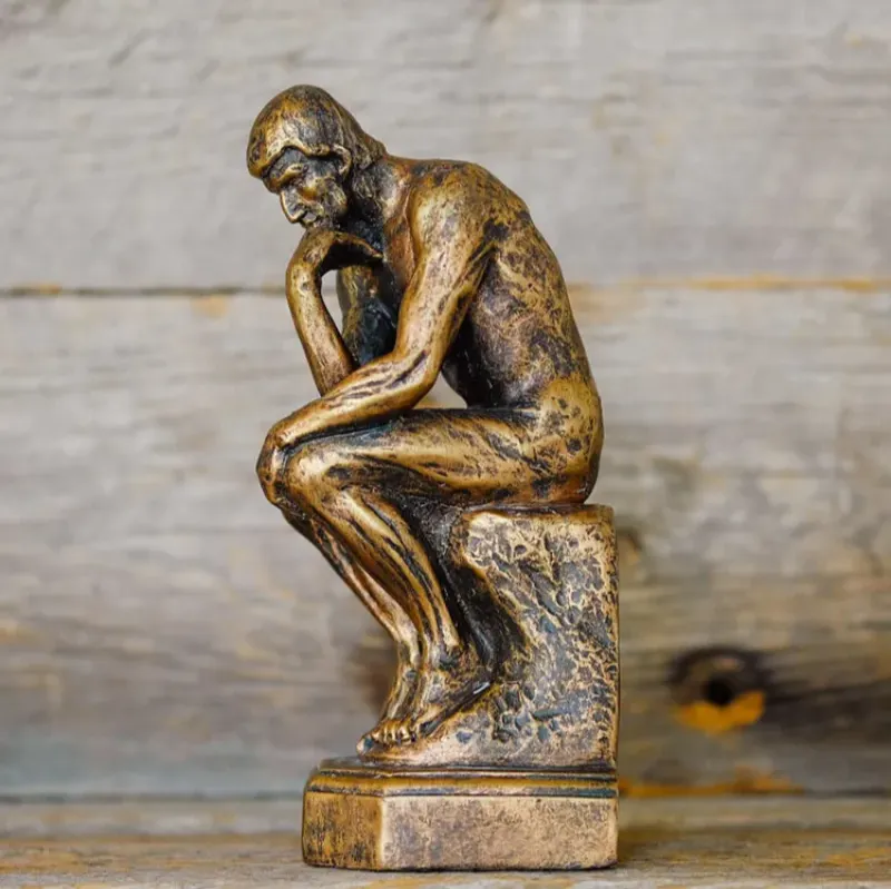 Image of a miniature bronze statue called The Thinker