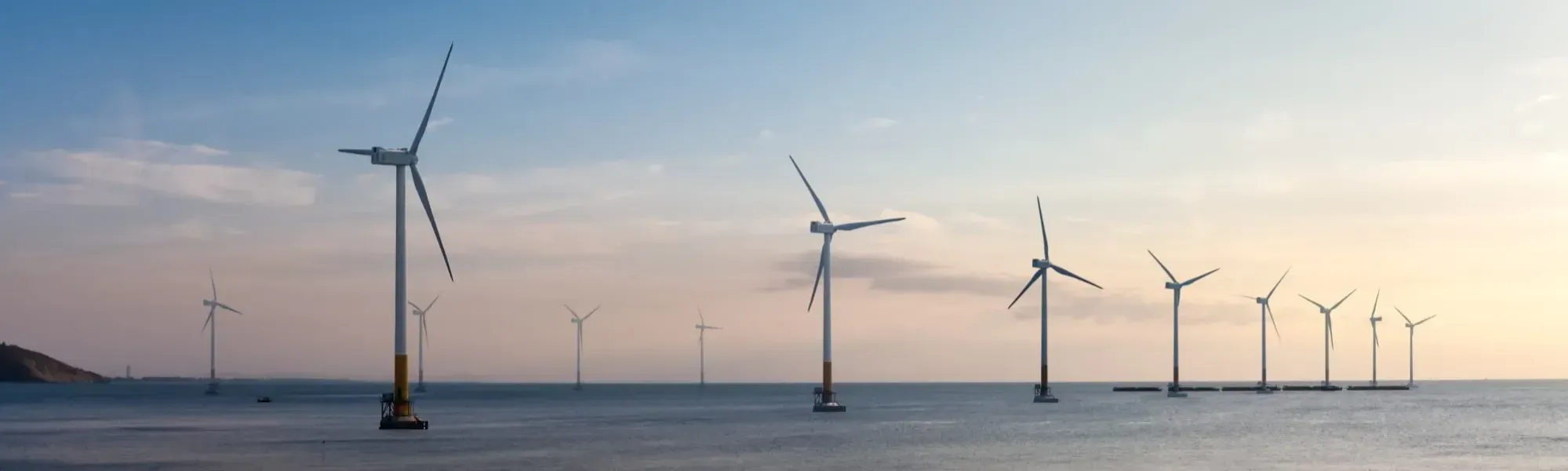 image of wind turbines in the sea at dawn