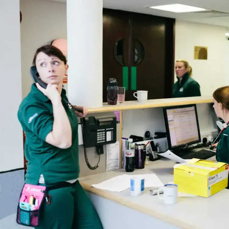 Nurse at reception on the phone